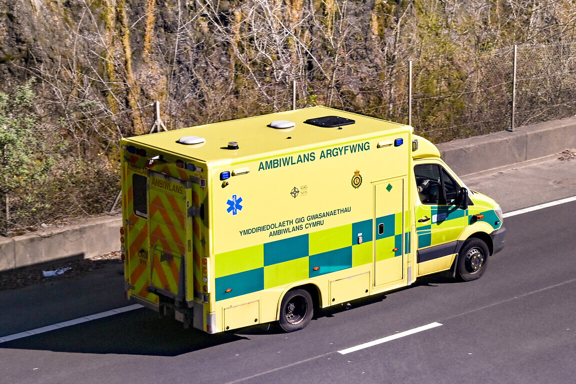 Aerial view of an ambulance driving on a dual carriageway.