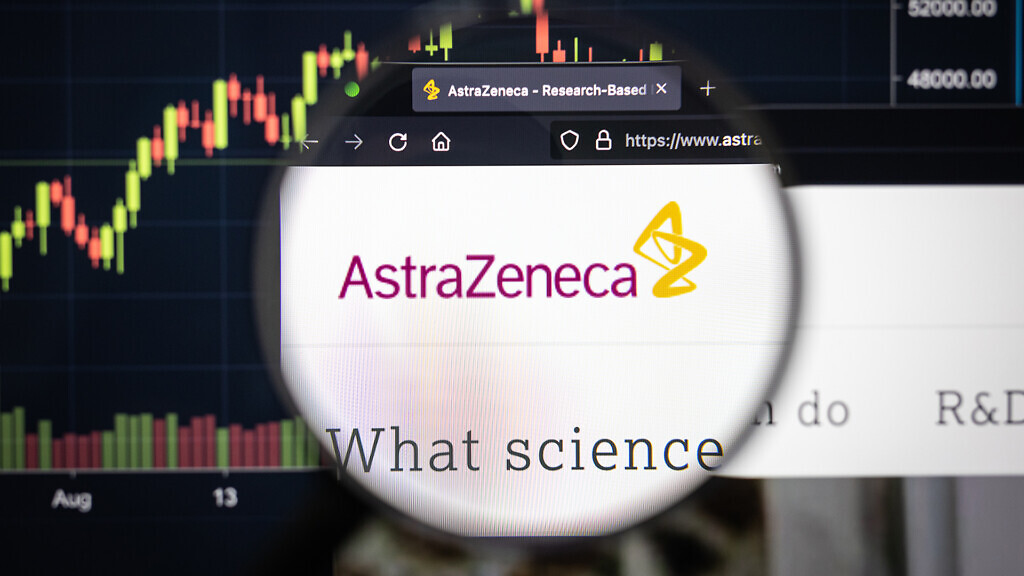 AstraZeneca company logo on a website with blurry stock market