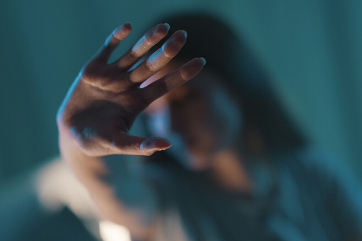 Young woman doing a stop sign with her hand