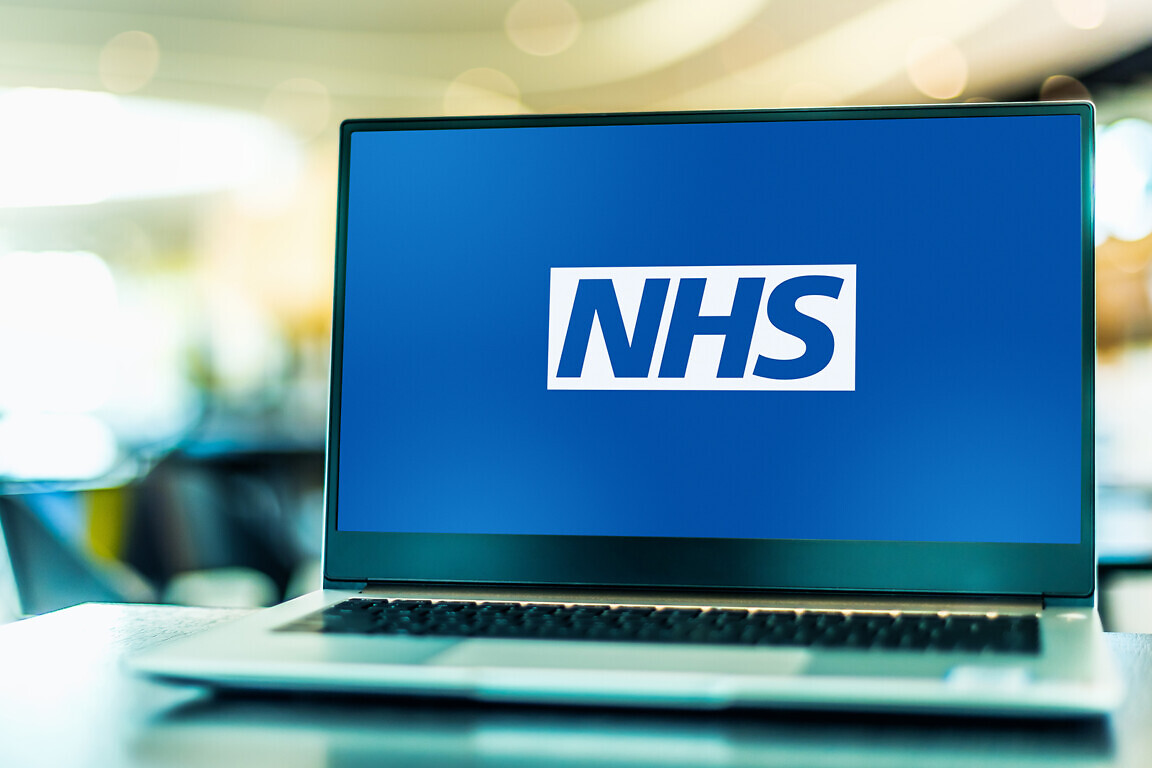 Laptop computer displaying logo of The National Health Service.