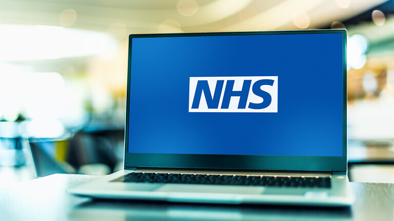 Laptop computer displaying logo of The National Health Service.