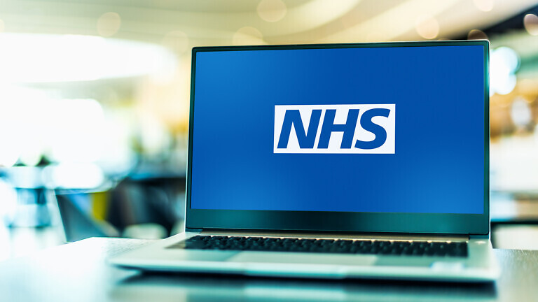 Laptop computer displaying logo of The National Health Service
