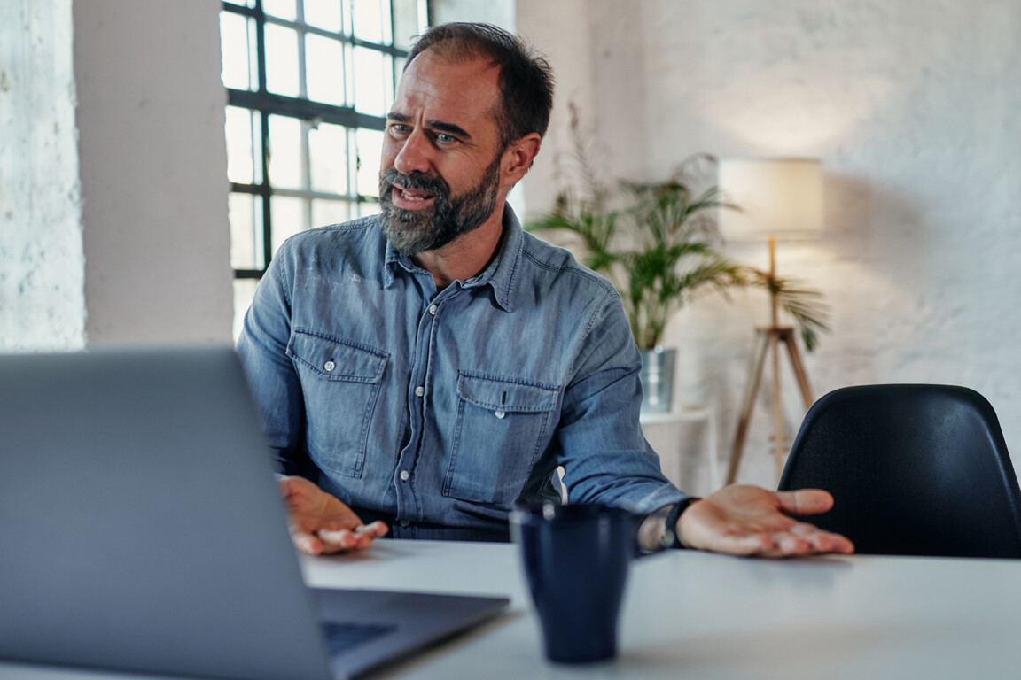 Man during online therapy session