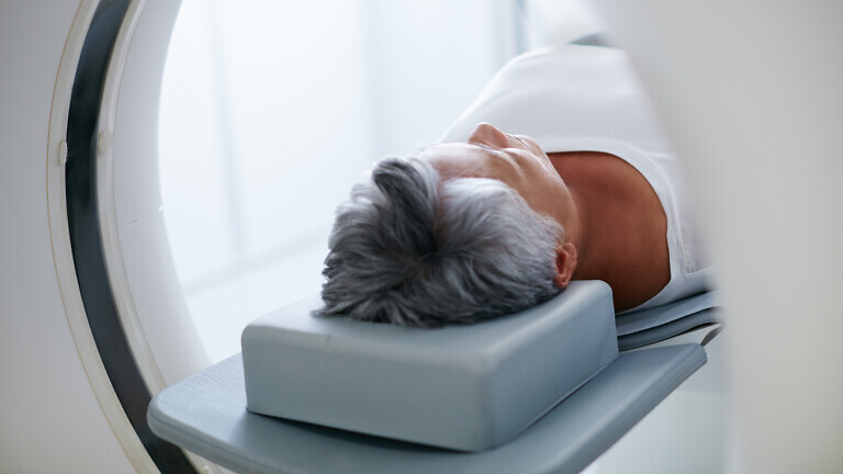 Shot of a senior woman about to have an MRI scan.