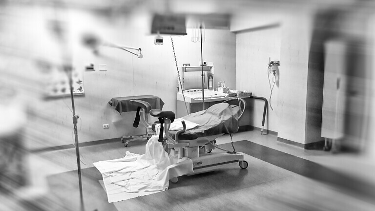View of an empty hospital bed in the maternity ward at a hospital.