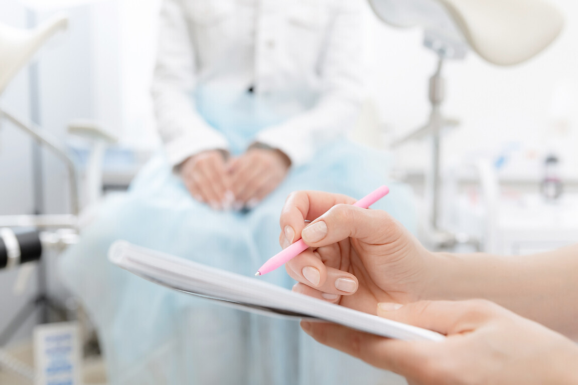 Young woman patient at gynecologist appointment consults in medical institution