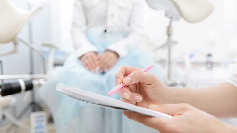 Young woman patient at gynecologist appointment consults in medical institution