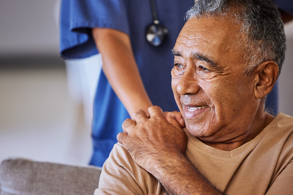 Nurse or doctor give man support during recovery or loss. Caregiver holding hand of her sad senior patient and showing kindness while doing a checkup at a retirement, old age home or hospital