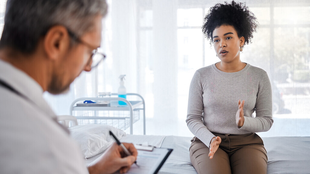 Healthcare, consulting and insurance with a black woman patient sitting in a hospital with her doctor. Medical, consultant and insurance with a female talking to a medicine professional for diagnosis