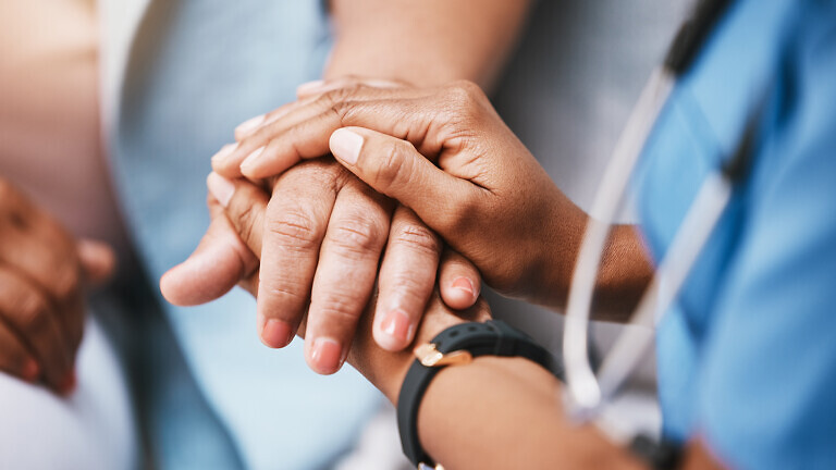 Empathy, trust and nurse holding hands with patient for help, consulting support and healthcare advice. Kindness, counseling and medical therapy in nursing home for hope, consultation and psychology