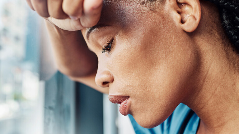 Doctor, black woman burnout and anxiety in hospital, workplace and tired in healthcare job, stress or headache. Nurse, sad and exhausted in medical clinic or depression in health hospital by window