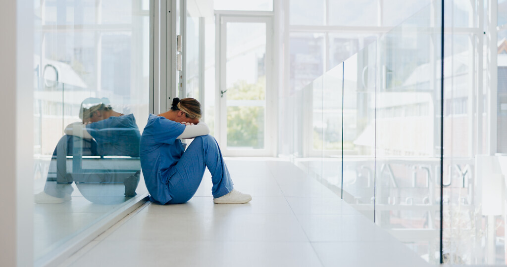 Doctor, stress and woman with depression, burnout and overworked in hospital, deadline and tired. Healthcare, medical professional and nurse crying for mistake, depressed and fatigue with anxiety