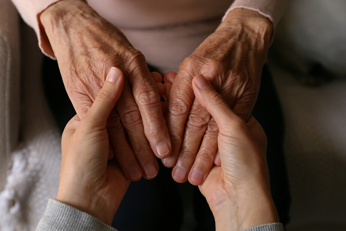 Cropped shot of elderly woman and female geriatric social worker