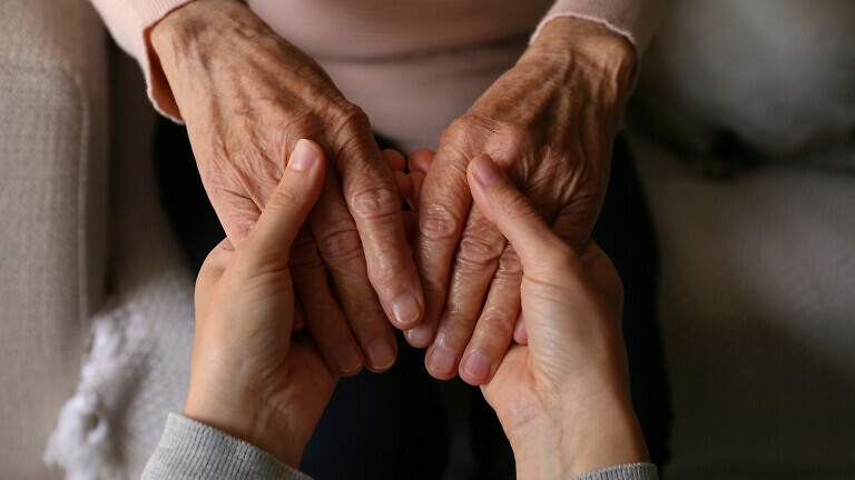 Cropped shot of elderly woman and female geriatric social worker