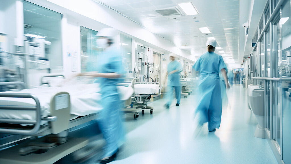 Long exposure blurred motion of medical doctors and nurses in a busy hospital.