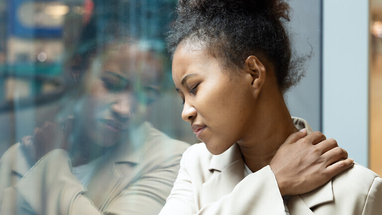 Office worker woman having shoulder sickness or neck pain from overwork or office syndrome