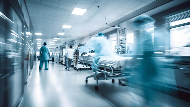 Hospital emergency team rush patient on gurney to the operating