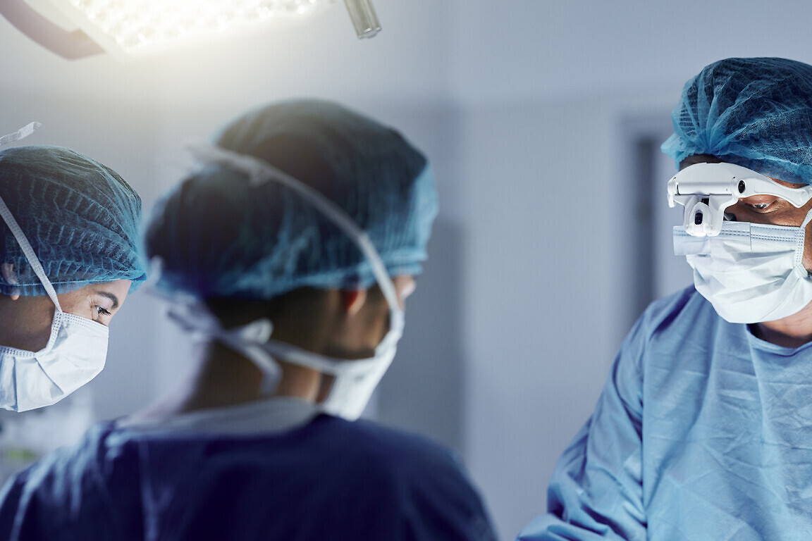 Surgery, team and mask on face with glasses for medical, healthcare and working in operation room. Surgeon, teamwork and people in hospital or clinic for healing, treatment or kidney transplant.