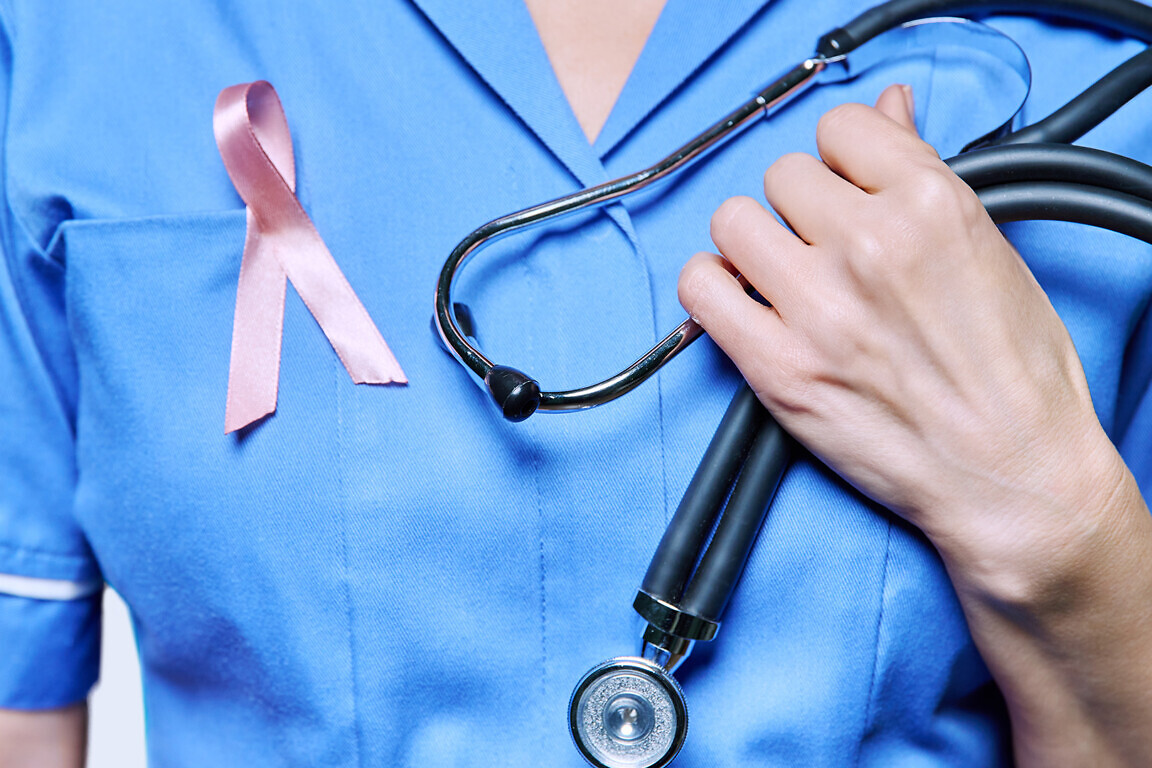 Close-up female nurse with with stethoscope, pink ribbon