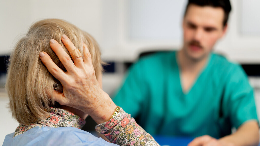 close up consultation between a doctor and an elderly patient in a plastic surgery clinic