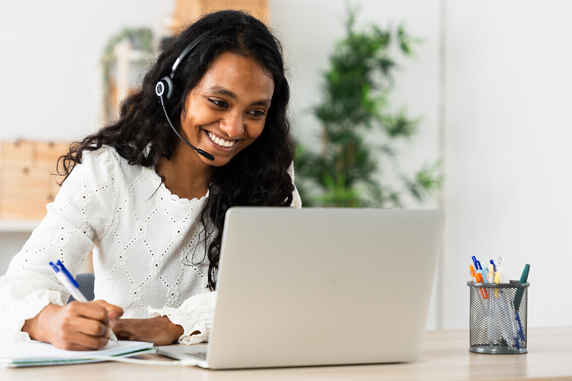 Positive phone assistance worker talking on headset