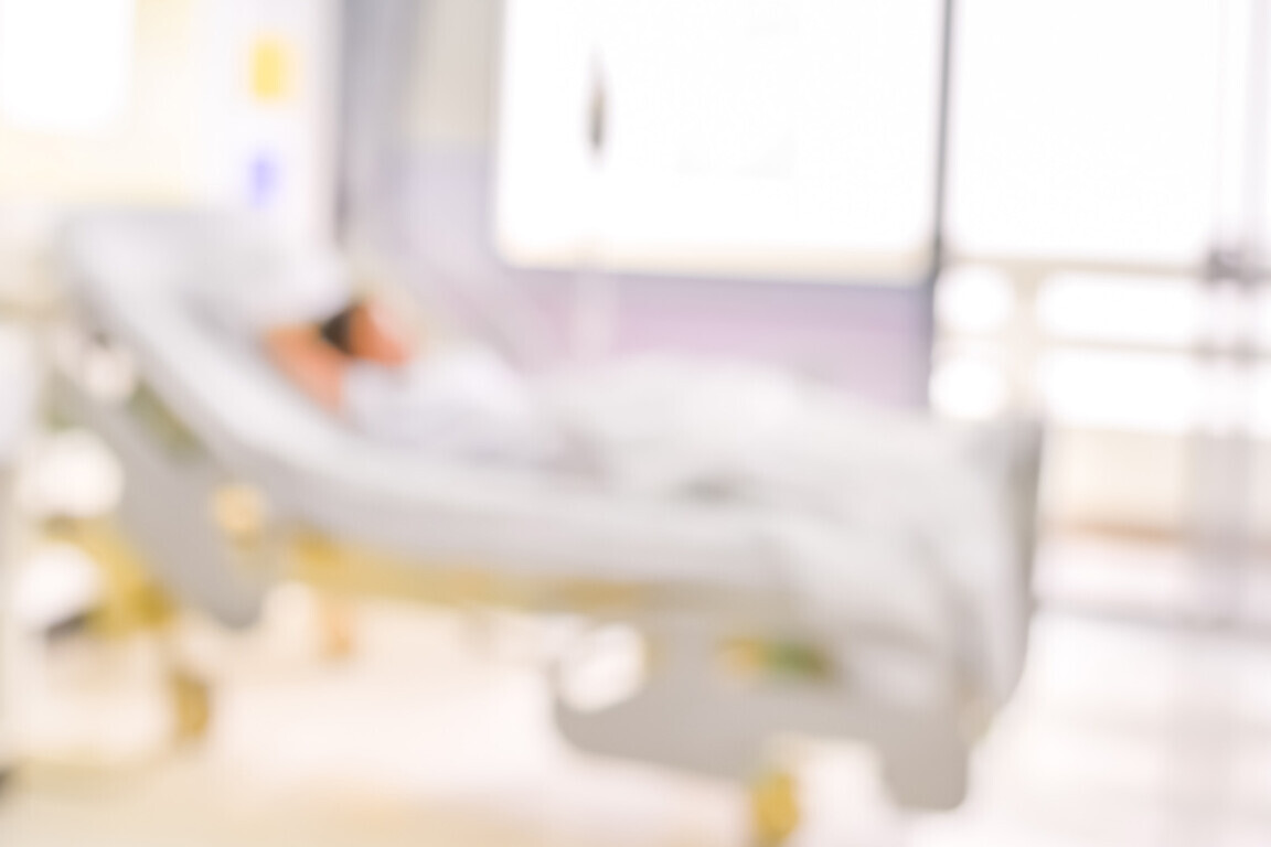blurred image of Patient with drip in hospital for background usage.