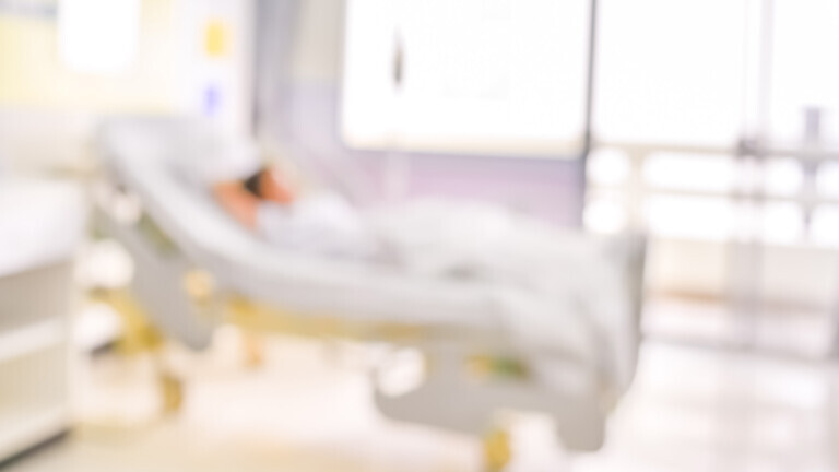 blurred image of Patient with drip in hospital for background usage.