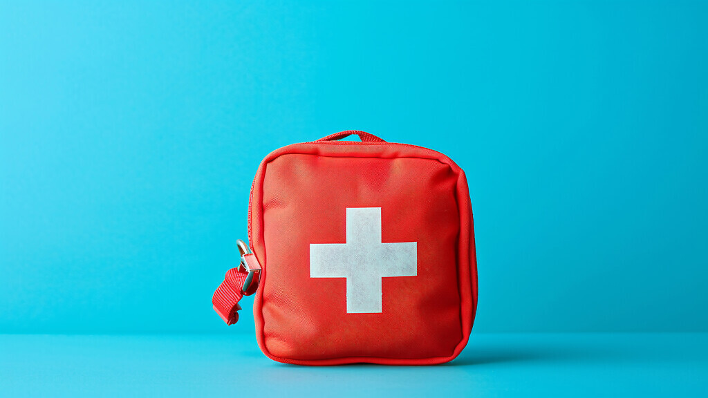 Red first aid kit on blue background.