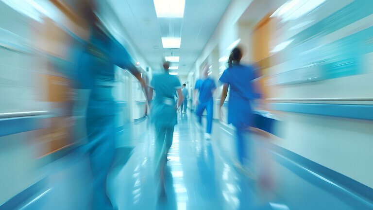 motion of medical doctors nurse in hospital ward interior wearin