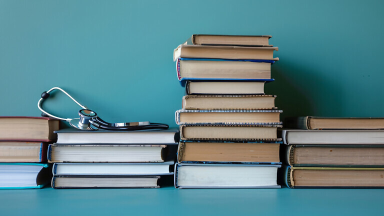 Stacked medical books and journals forming a knowledgeable frame