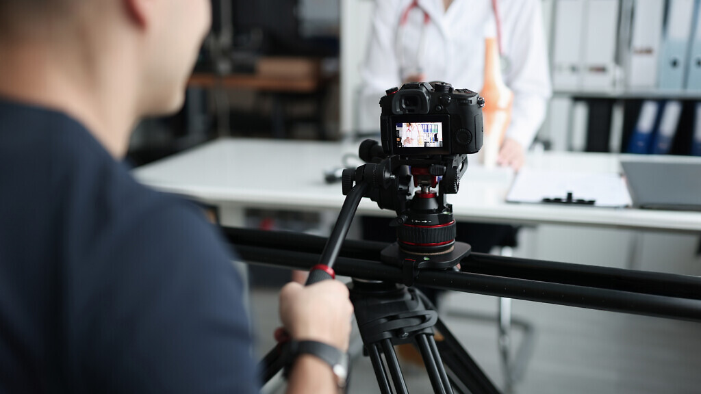 Female doctor recording vlog video about medicine and health care