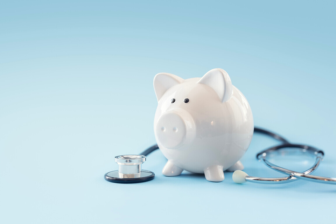 Piggy bank with stethoscope background concept for financial health check-up or saving for medical insurance costs