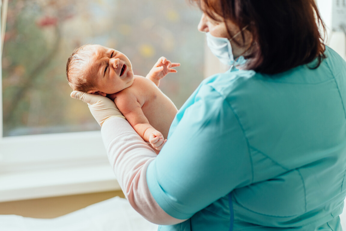 Midwife with newborn baby