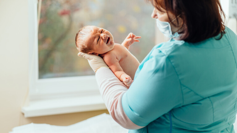 Midwife with newborn baby