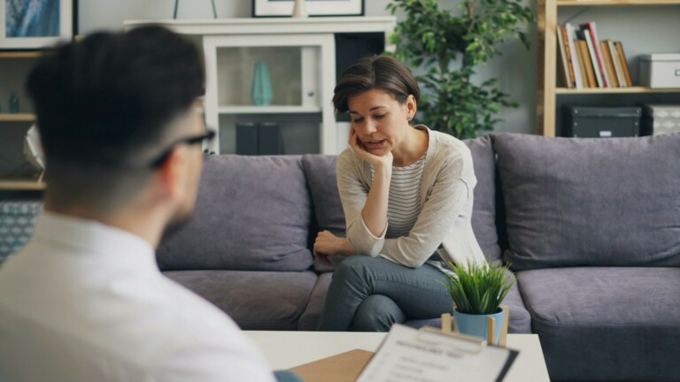 URL: https://unsplash.com/photos/a-woman-sitting-on-a-couch-talking-to-a-man-SktdARcCuys